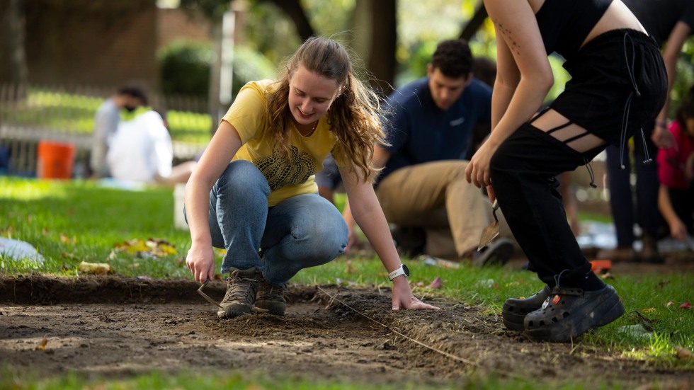 Students explore in the soil