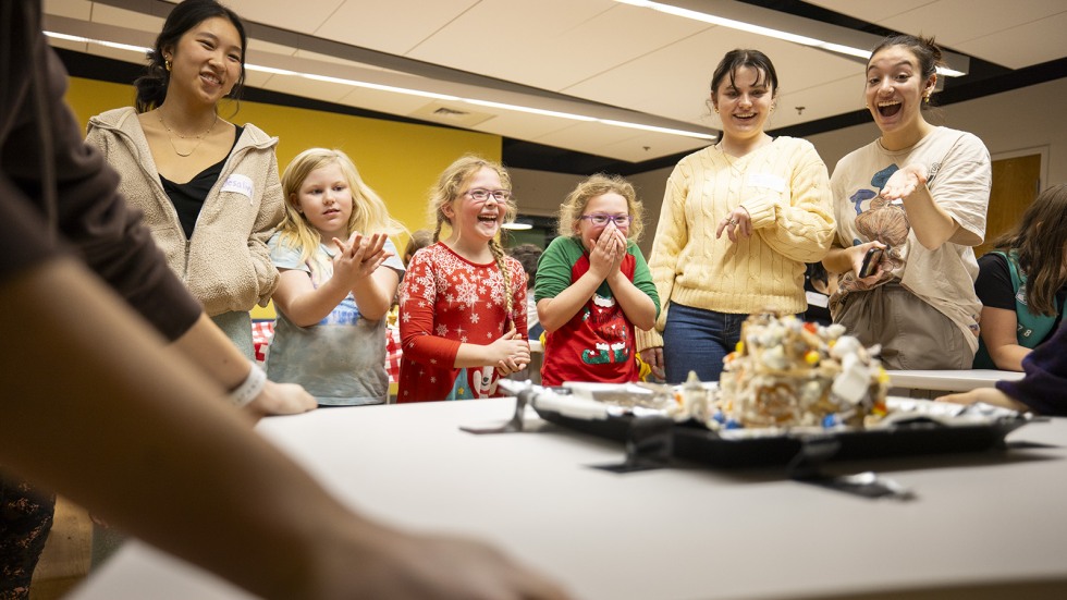 Girl Scouts smile as their creation is tested in the shake test 