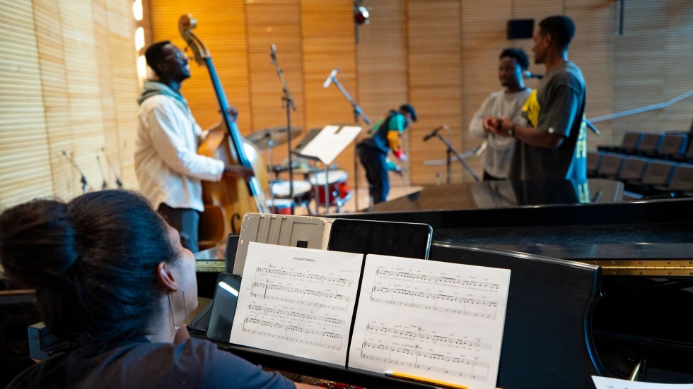 group of musicians rehearsing in a recital hall