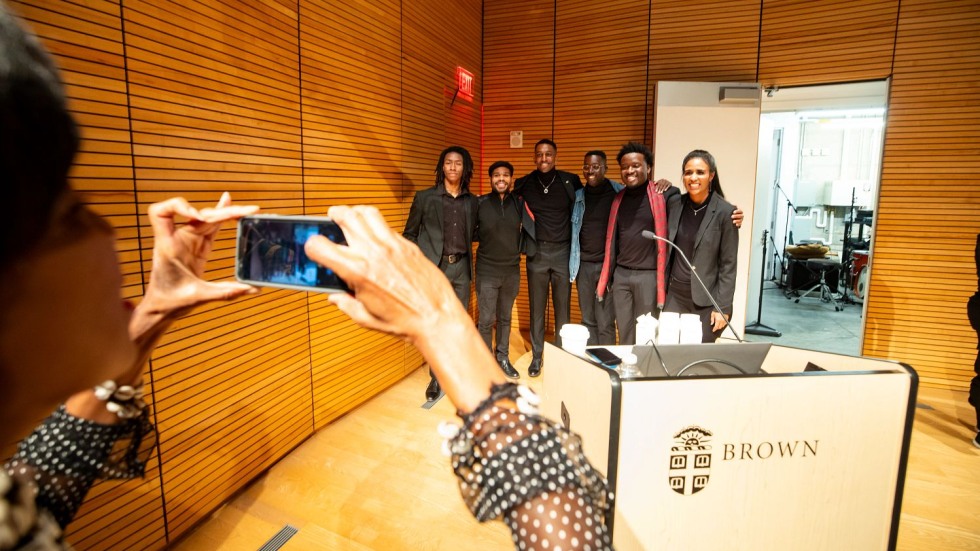 group of people posing for a photo inside a recital hall