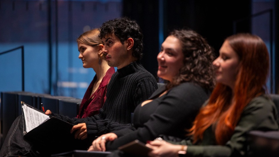 Students watch the work session. 