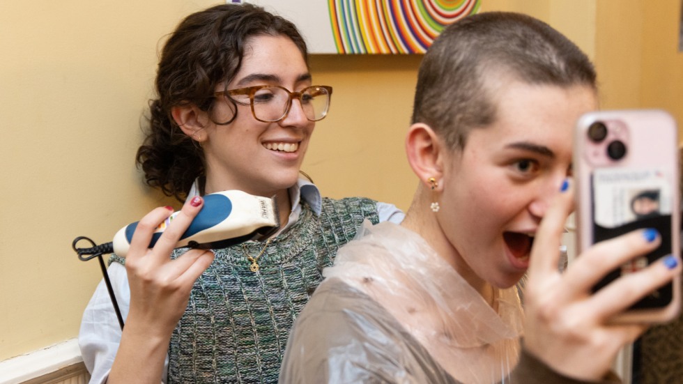 Student reacts after getting her head shaved 