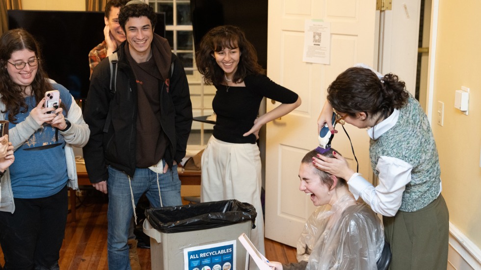 Group reacts to student getting head shaved