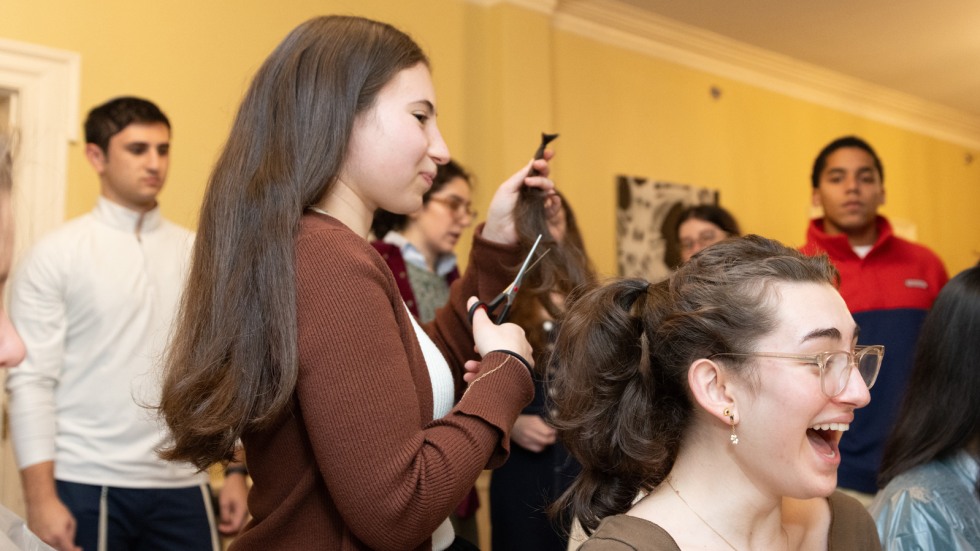 Student cuts a ponytail off another's head