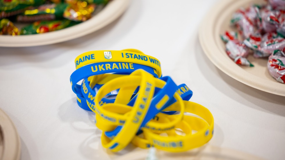 detail shot of 'i stand with ukraine' bracelets on table