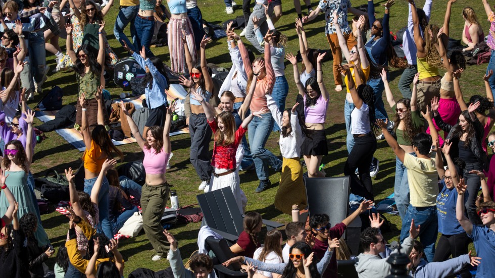 crowd of students dances on College Green