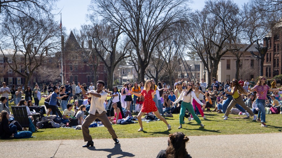 crowd of students dances on College Green