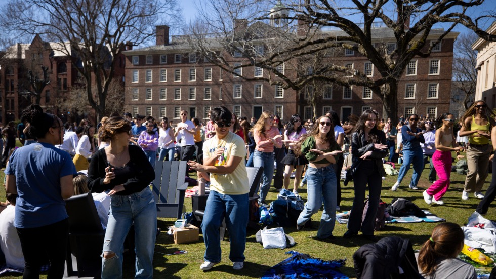 crowd of students dances on College Green