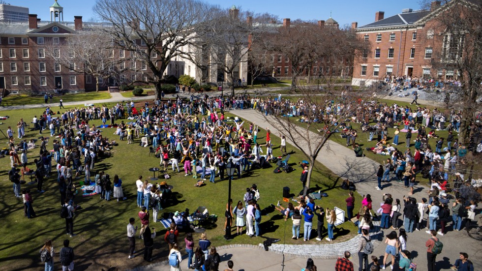 crowd of students dances on College Green