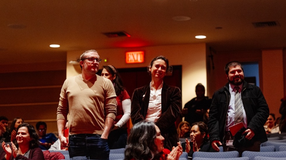 People stand to be recognized in an auditorium