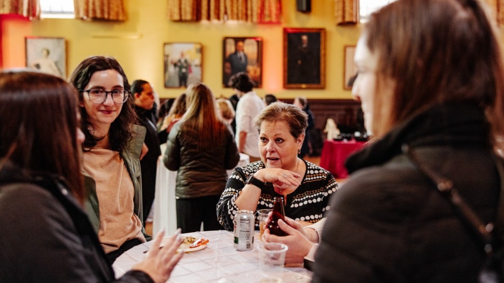 People stand around a table talking