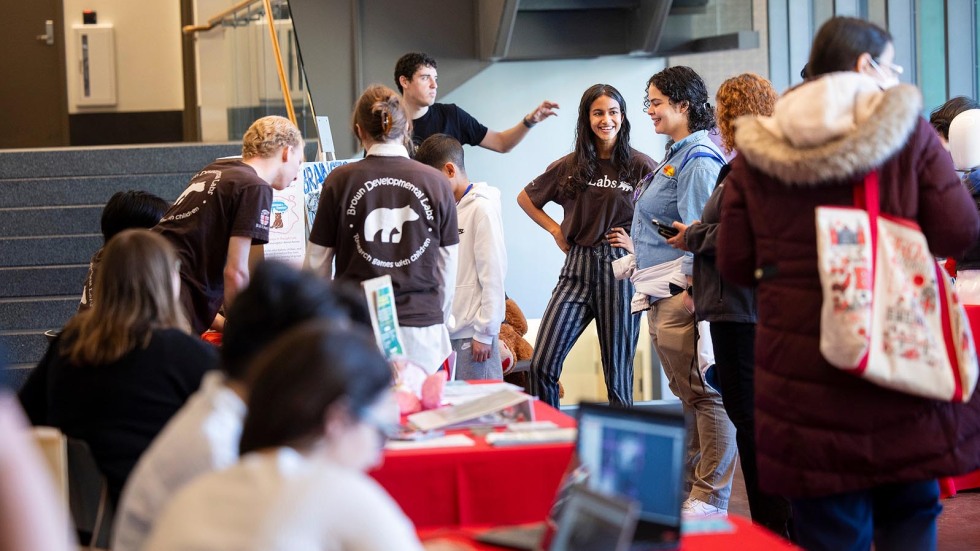 visitors talk to Brown researchers 