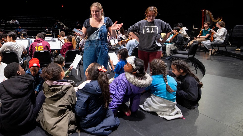 kids gathered around college student