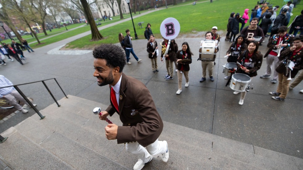 The band leader walks up a set of steps