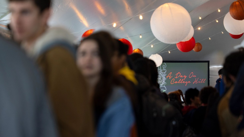 A screen under a tent reads "A Day on College Hill"