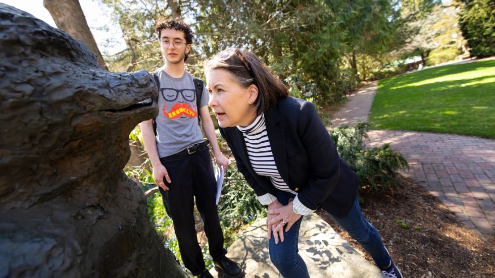 Curator examines bear sculpture 