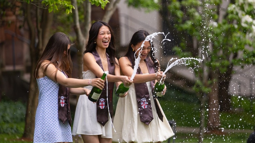 Graduates popping Champagne 