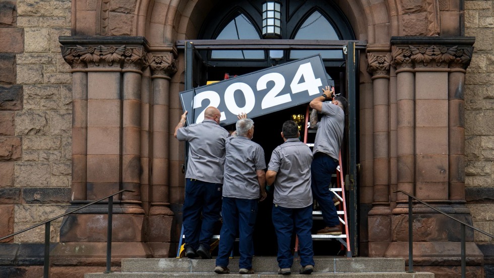 Hanging a sign that reads: 2024