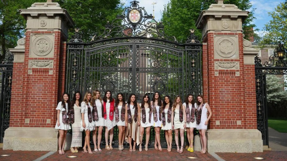 graduates in front of gates