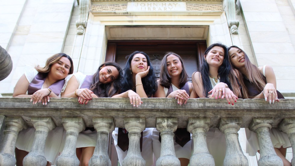 graduates posing on stairs