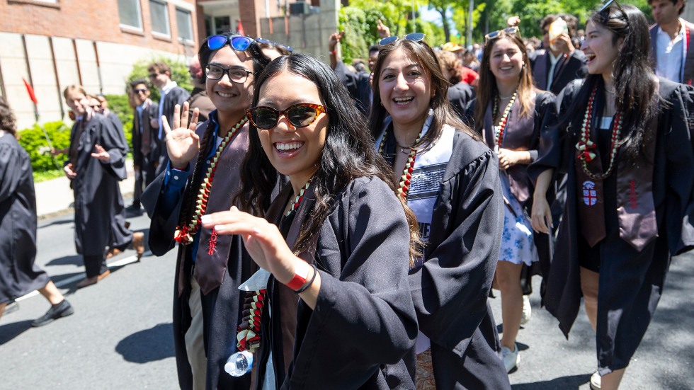 students smile at camera walking down waterman st
