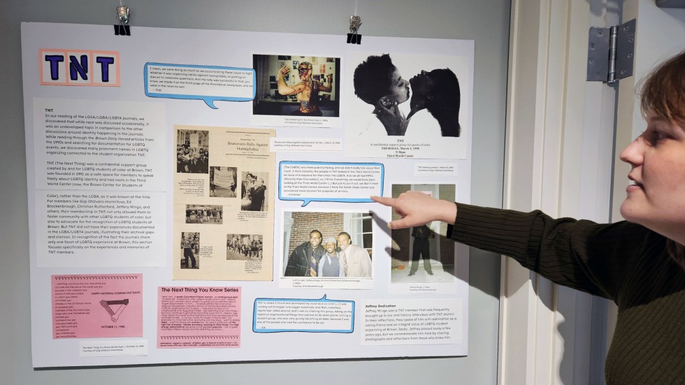 Ellen Huggins points to a display poster