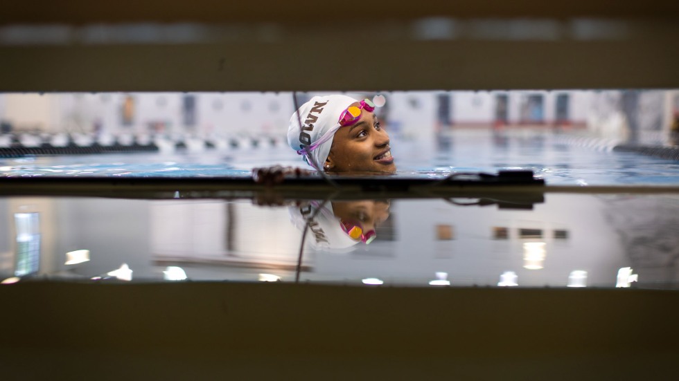 Amie Barrow in the pool wearing Brown swim cap