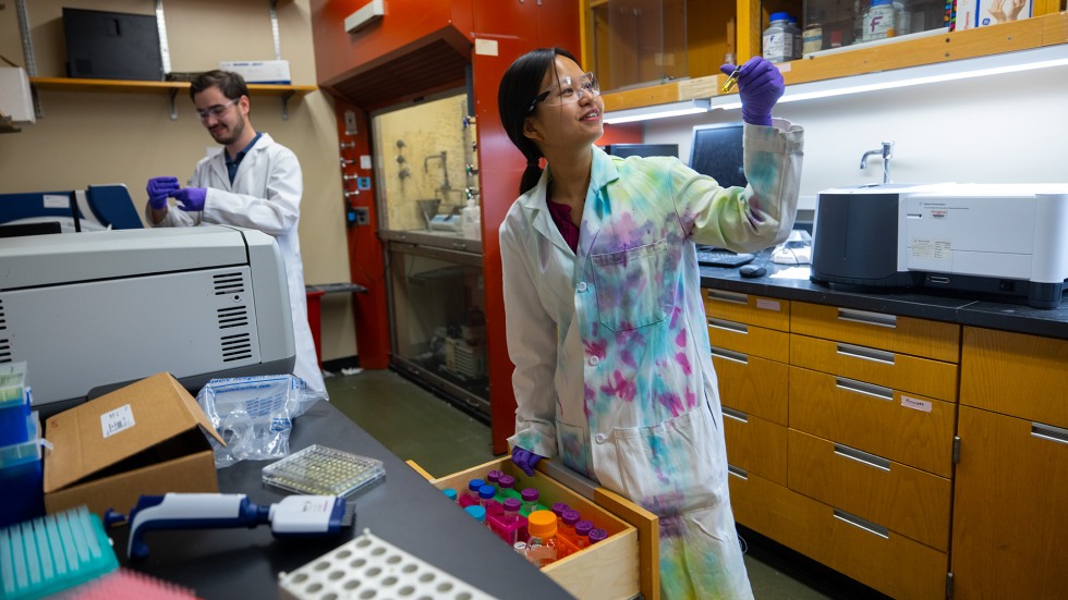 Woman looks at a vial