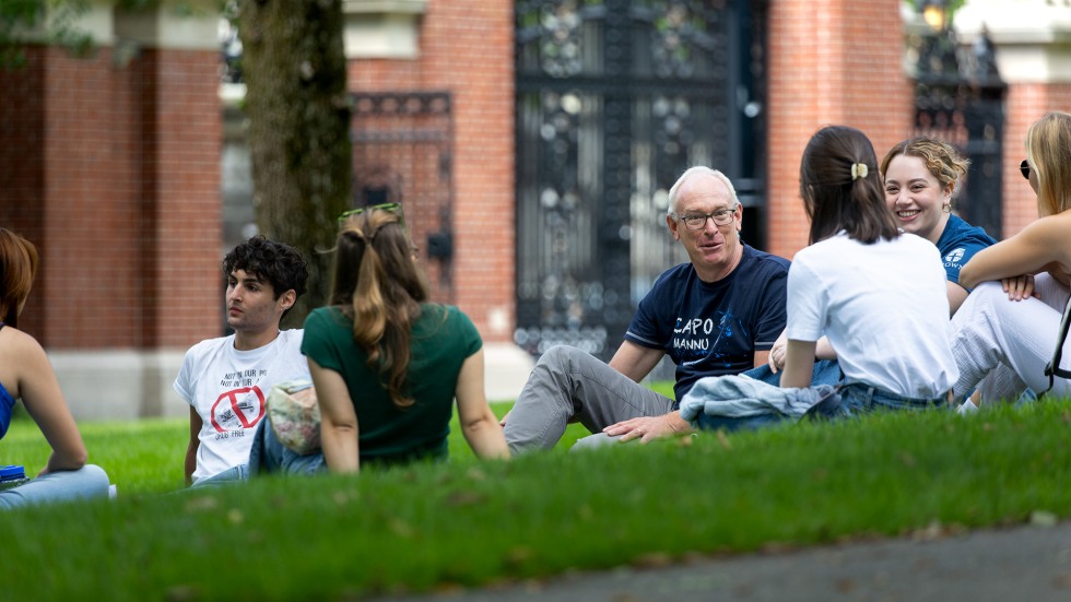 Students meeting with faculty on the grass