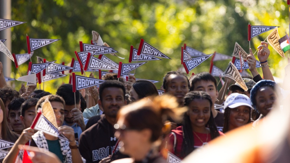 students wave Brown pennants at Convocation