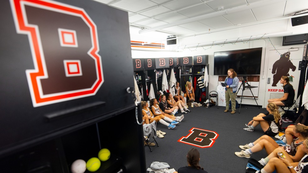 Percy Unger gives voting presentation in field hockey locker room 