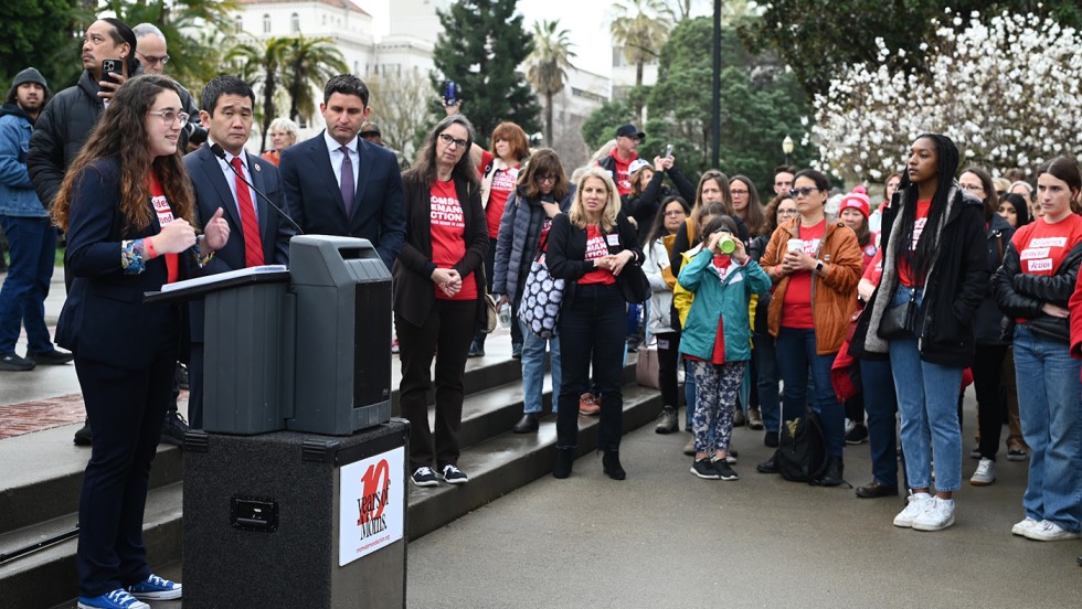 Mia Tretta addresses an outdoor crowd