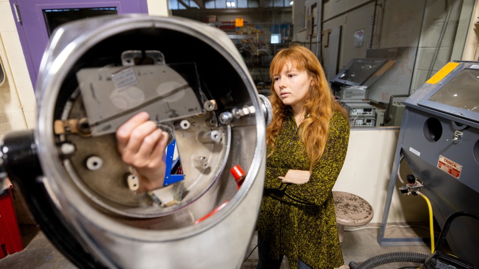 Zoe Goldemberg works on tower viewer optics 