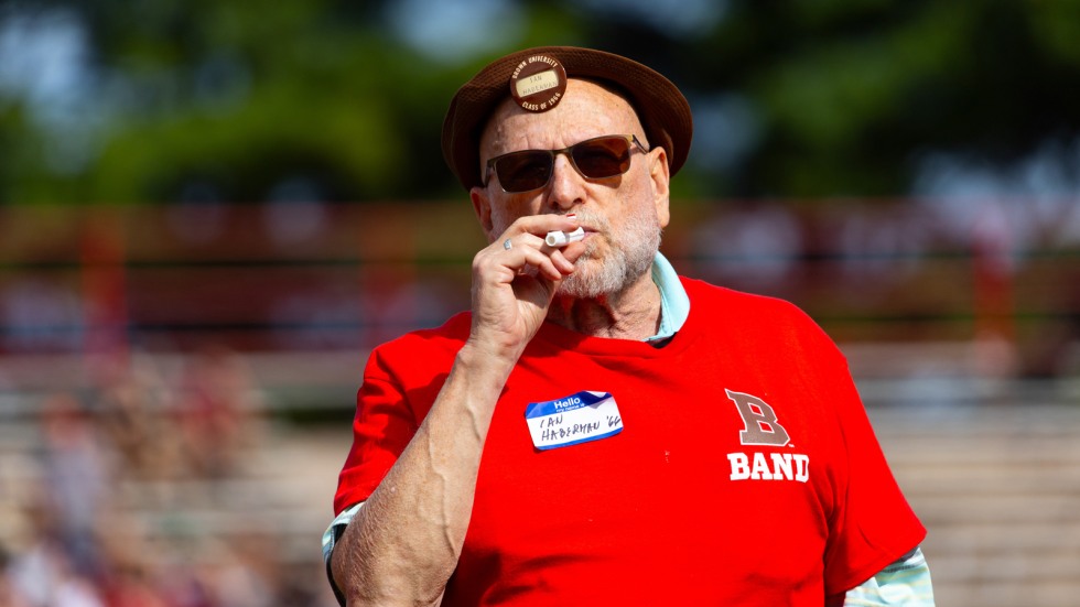 Band alumni plays kazoo on the field