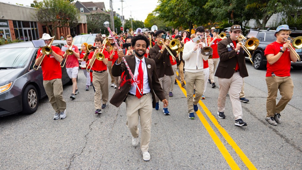 Bandleader leads Brown Band through a street procession