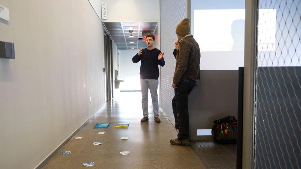 Logan Tullai meets with art installer