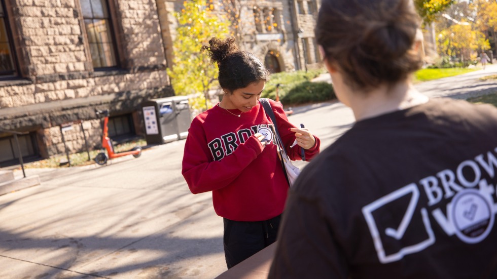 Students puts on 'I voted' sticker
