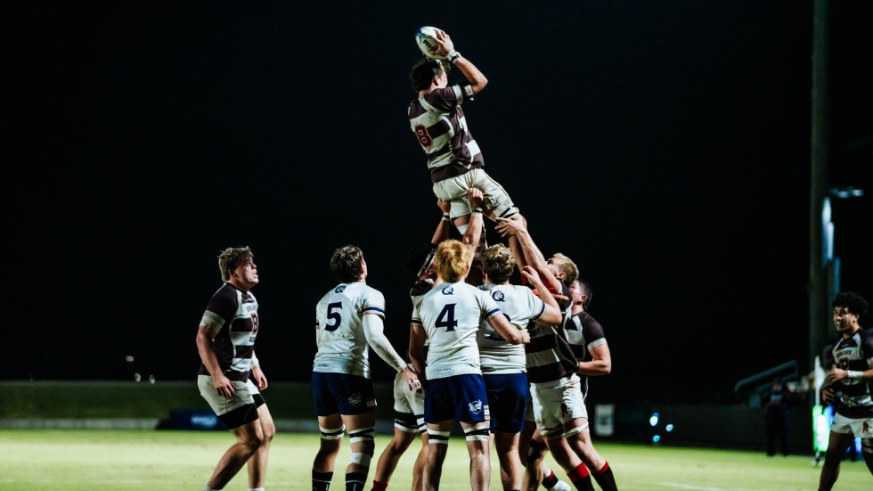 players hold up another while he catches the ball