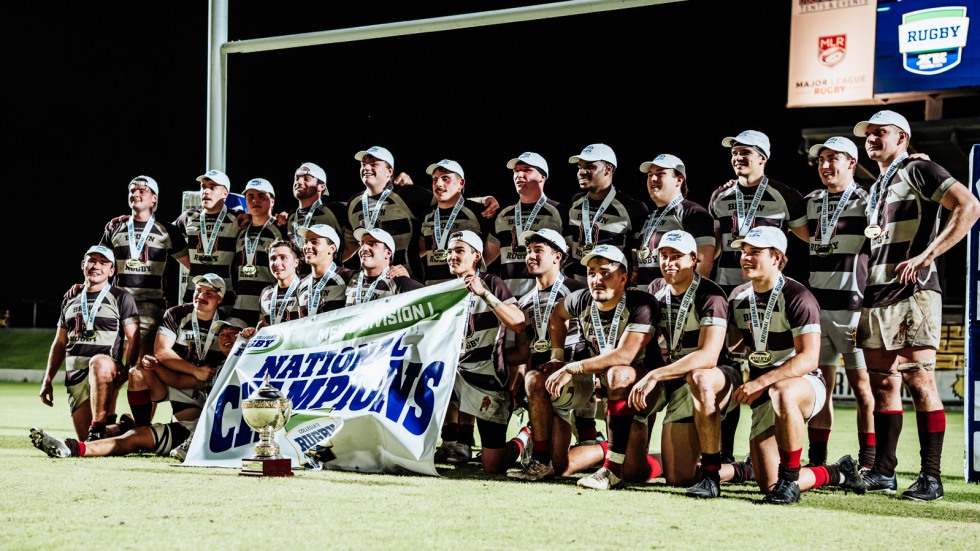 winning team poses with banner