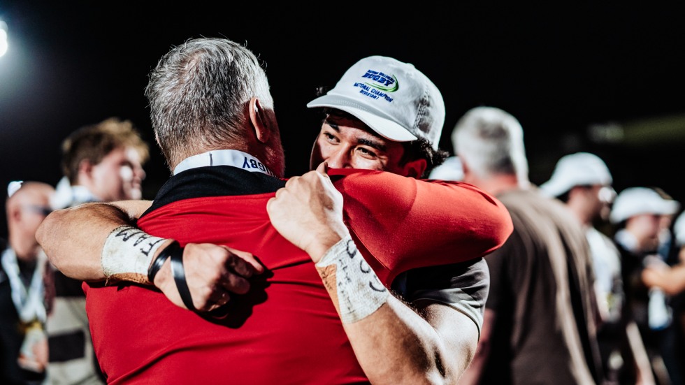 player hugs coach after win