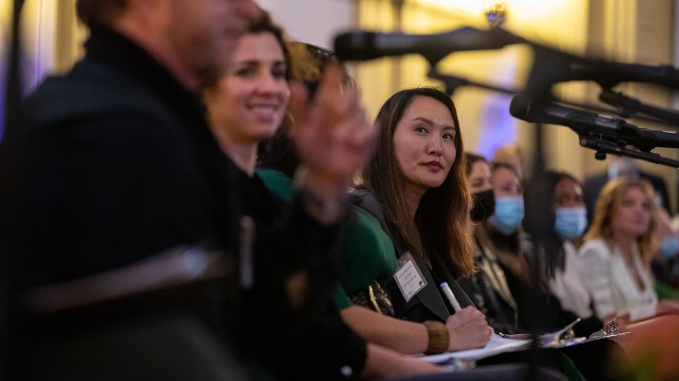 People lined up at a table in front of microphones