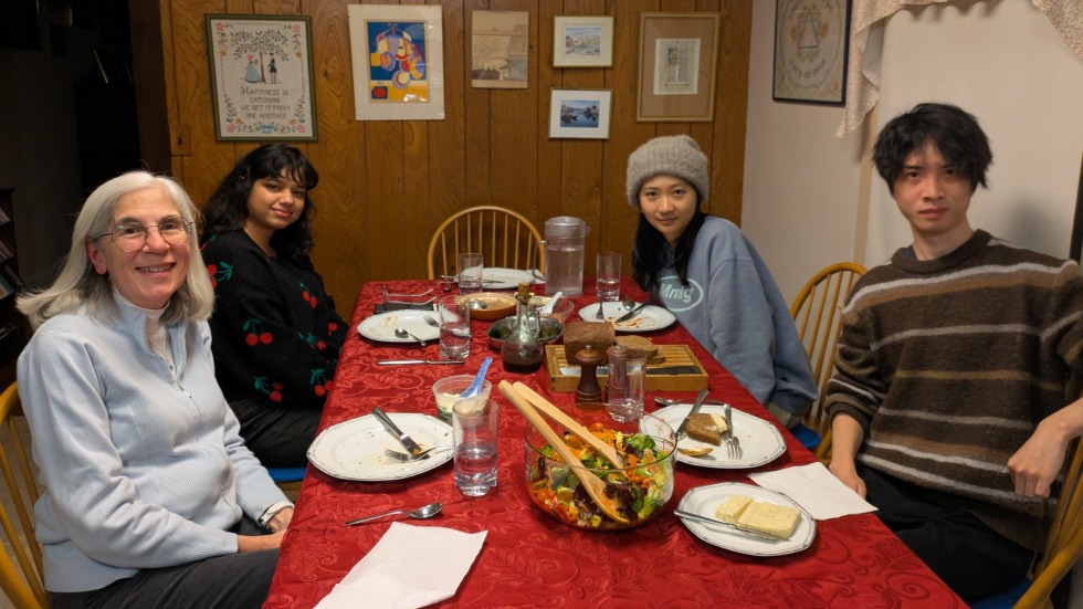 four people seated at a dinner table