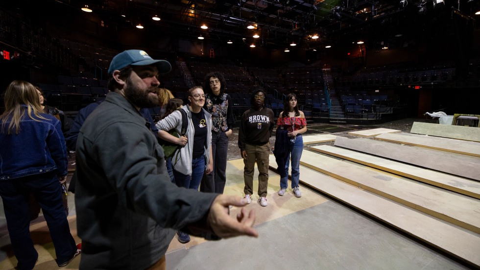 Alex Haynes speaks to a class in a theater