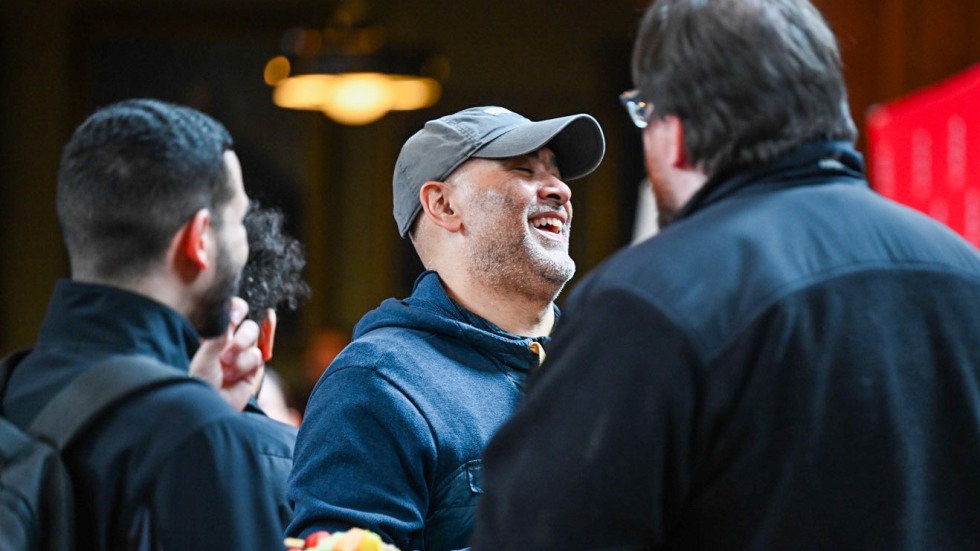 Three people talking and laughing