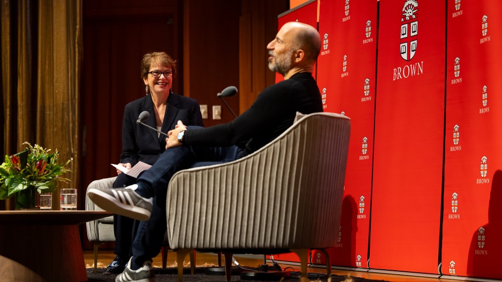 Dara Khosrowshahi and Christina Paxson seated on the stage and conversing