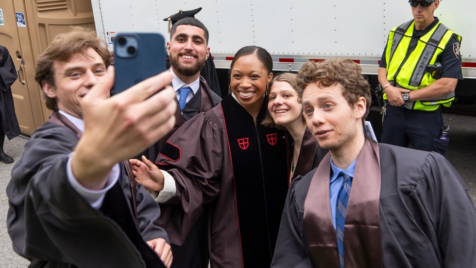 Brown graduates stop to take a selfie with the speaker, Allyson Felix