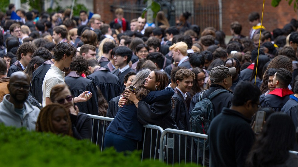 Graduating seniors stop to hug friends and family