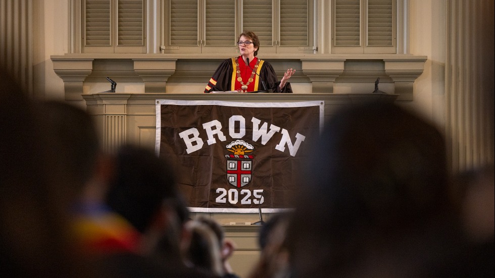 Brown president Christina Paxson speaks from the podium, introducing Allyson Felix