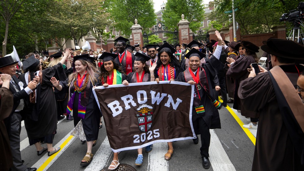 Marshals carry Class of 2025 banner during procession