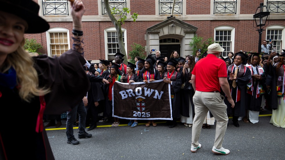 Marshals carry Class of 2025 banner during procession